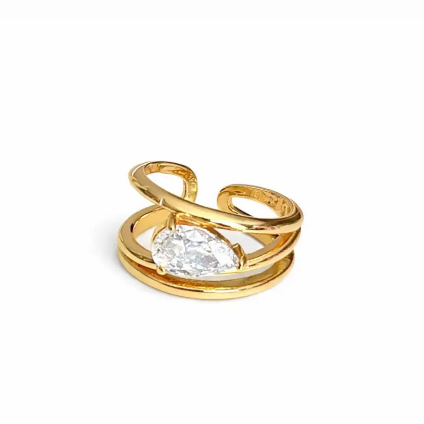 Gold ring with a clear gemstone on a white background
